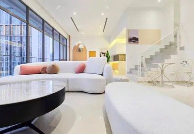 a living room with a white couch and a table at KL Penthouse Skyline View in Bukit Bintang Fairlane in Kuala Lumpur