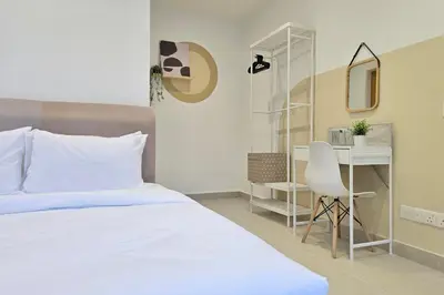 a bedroom with a bed and a desk and a chair at KL Penthouse Skyline View in Bukit Bintang Fairlane in Kuala Lumpur