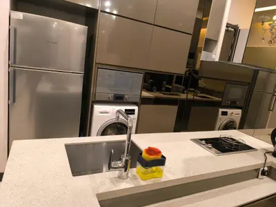 a kitchen with a sink and a kitchen with appliances at Dorsett Luxury Residence KL in Kuala Lumpur