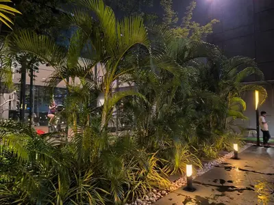 a group of palm trees in a building with candles at Dorsett Luxury Residence KL in Kuala Lumpur