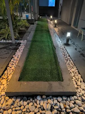 a walkway in a building with grass and rocks at Dorsett Luxury Residence KL in Kuala Lumpur