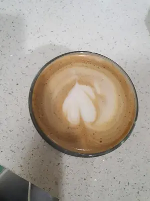 a cup of coffee sitting on a table at Kiaramas Gateway Residence in Kuala Lumpur