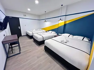 a hotel room with two beds and a desk at Seeds Hotel PV12 in Kuala Lumpur