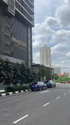 a street with cars parked in front of a building at MAJESTIC RESlDENCE KLCC in Kuala Lumpur