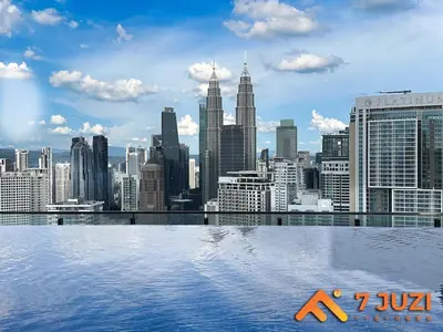 a view of a city skyline from a rooftop swimming pool at KLCC Cozy Suite 21F with Best View Infinity Pool in Kuala Lumpur