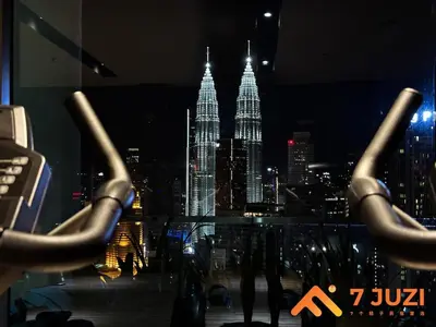 a view of a city skyline at night at KLCC Cozy Suite 21F with Best View Infinity Pool in Kuala Lumpur