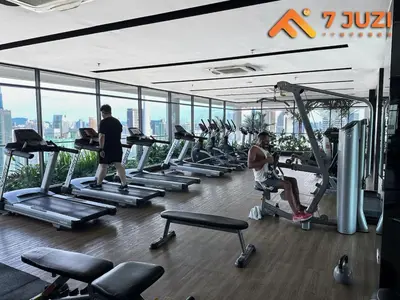 a gym with several people exercising on tread machines at KLCC Cozy Suite 21F with Best View Infinity Pool in Kuala Lumpur