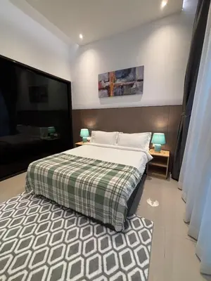 a bedroom with a large bed and a couch at KLCC Cozy Suite 21F with Best View Infinity Pool in Kuala Lumpur