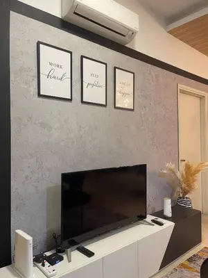 a living room with a large flat screen tv on a wall at Arte Ampang KLCC 2 BR Homestay, 4-6 pax in Ampang