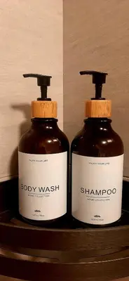 two bottles of body wash sitting on a shelf at Arte Ampang KLCC 2 BR Homestay, 4-6 pax in Ampang