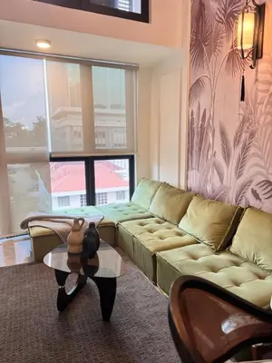 a living room with a couch and a teddy bear on a table at Deluxe Duplex Studio Suite at Agile Bukit Bintang in Kuala Lumpur
