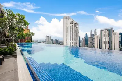 a swimming pool on the roof of a building at Majestic by Avery at KLCC#Located in the City Center#10 mins Walk to Twin Towers#Rooftop Infinity pool#\u4e2d\u82f1\u6587\u623f\u4e1c in Kuala Lumpur