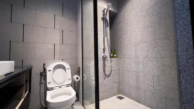 a bathroom with a toilet and a shower at Scarletz Suite KLCC By Light House 3 in Kuala Lumpur