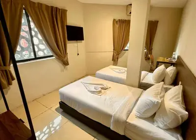 a hotel room with two beds and a window at Swing & Pillows - Chow Kit Road, Kuala Lumpur in Kuala Lumpur