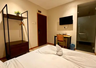 a bedroom with a bed and a desk and a tv at Swing & Pillows - Chow Kit Road, Kuala Lumpur in Kuala Lumpur