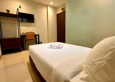a hotel room with a bed with towels on it at Swing & Pillows - Chow Kit Road, Kuala Lumpur in Kuala Lumpur