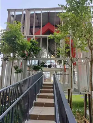 a staircase leading up to a building with trees at Stay At KL 4 pax at Bukit Bintang KL Monorail in Kuala Lumpur
