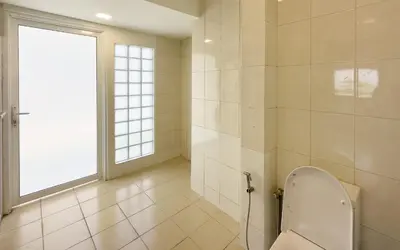 a bathroom with a toilet and a window at Damansara Heights Luxury Villa with Private Pool in Kuala Lumpur