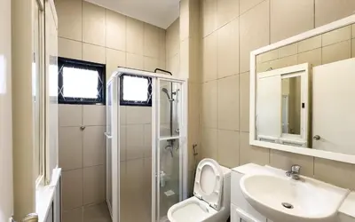 a bathroom with a toilet and a sink and a shower at Damansara Heights Luxury Villa with Private Pool in Kuala Lumpur
