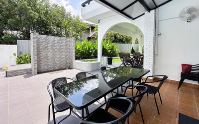 a patio with a table and chairs on a patio at Damansara Heights Luxury Villa with Private Pool in Kuala Lumpur