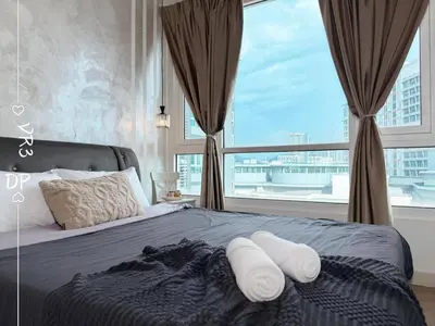 a bedroom with a bed with pillows and a large window at VR3 2R2B 6pax Sunway Velocity LINK Mall MRT in Kuala Lumpur