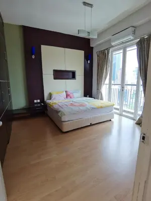 a bedroom with a bed and a large window at Seri Bukit Ceylon By S&S in Kuala Lumpur