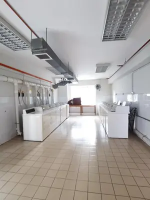 a large kitchen with white appliances in a room at Seri Bukit Ceylon By S&S in Kuala Lumpur