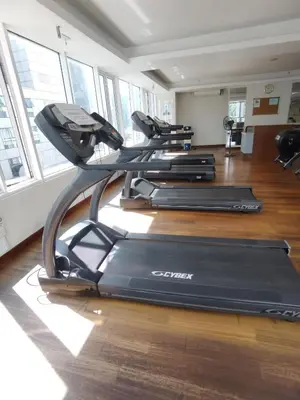 a gym with two treadmills in a room at Seri Bukit Ceylon By S&S in Kuala Lumpur