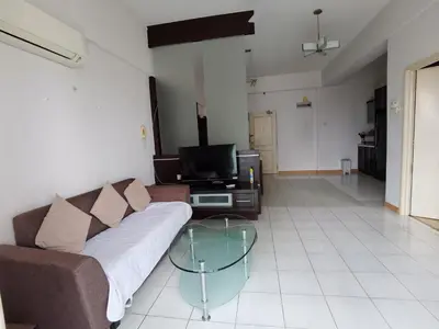 a living room with a couch and a glass table at Seri Bukit Ceylon By S&S in Kuala Lumpur