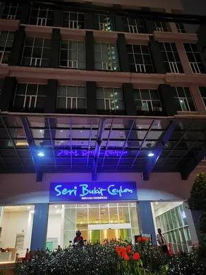 a building with a blue sign in front of it at Seri Bukit Ceylon By S&S in Kuala Lumpur