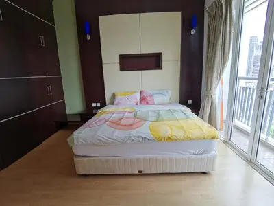 a bedroom with a bed and a large window at Seri Bukit Ceylon By S&S in Kuala Lumpur
