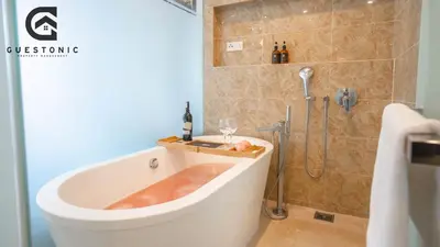 a bathroom with a tub and a shower with a sink at Dorsett Residences Bukit Bintang by Guestonic in Kuala Lumpur
