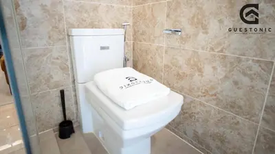 a bathroom with a white toilet and a shower at Dorsett Residences Bukit Bintang by Guestonic in Kuala Lumpur