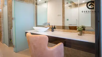 a bathroom with a counter with a sink and a chair at Dorsett Residences Bukit Bintang by Guestonic in Kuala Lumpur
