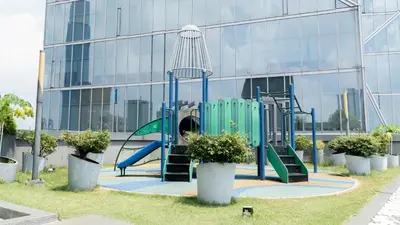 a playground in front of a glass building at Dorsett Residences Bukit Bintang by Guestonic in Kuala Lumpur