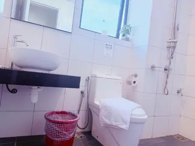 a bathroom with a white toilet and a sink at Chamber Luxury Serviced Suites KL in Kuala Lumpur