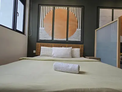 a bedroom with a large bed with a large window at Chamber Luxury Serviced Suites KL in Kuala Lumpur