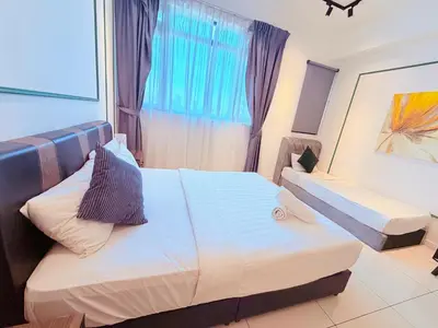 a hotel room with two beds and a window at Chamber Luxury Serviced Suites KL in Kuala Lumpur