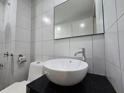 a white bathroom with a sink and a toilet at GRAND Suites Chamber AT Klcc in Kuala Lumpur