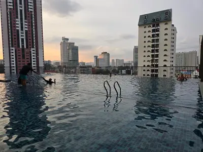 a person standing in a swimming pool in a city at GRAND Suites Chamber AT Klcc in Kuala Lumpur
