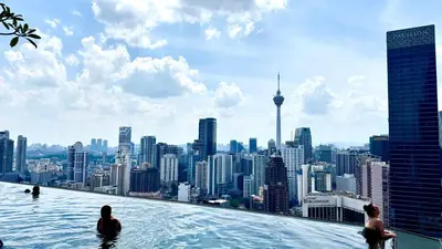 a infinity pool with a view of a city at Visitors Axon Residence Bukit Bintang KL City Center in Kuala Lumpur