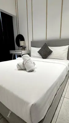 a large white bed with two pillows on it at Visitors Axon Residence Bukit Bintang KL City Center in Kuala Lumpur