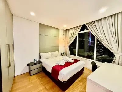a bedroom with a bed and a large window at Votrex Suites KLCC By Classic Home in Kuala Lumpur