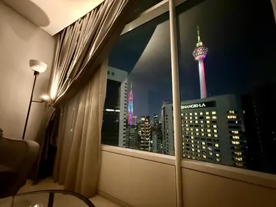 a room with a window with a view of the msg tower at Votrex Suites KLCC By Classic Home in Kuala Lumpur