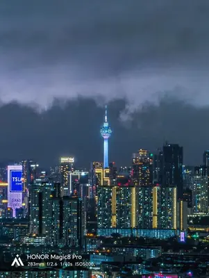 a city skyline with a needle lit up at night at Votrex Suites KLCC By Classic Home in Kuala Lumpur