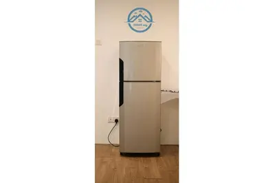 a refrigerator in the corner of a room at Binjai 8 Premium Soho by Heaven Stay in Kuala Lumpur