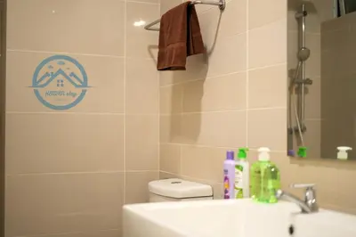 a bathroom with a sink and a toilet with a sticker on the wall at Binjai 8 Premium Soho by Heaven Stay in Kuala Lumpur