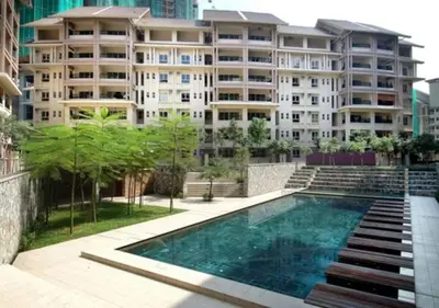 a building with a swimming pool in front of a building at Serimaya Condominium 5 mins from twin tower KLCC in Kuala Lumpur
