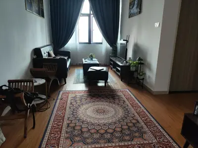 a living room with a couch and a rug at Legasi Kampong Bharu in Kuala Lumpur