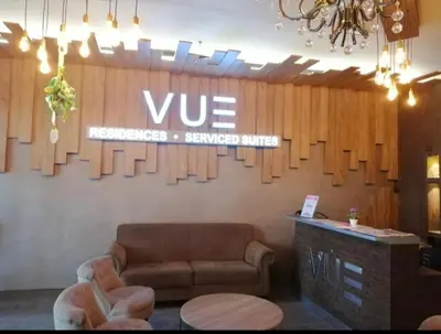 a living room with a couch and a sign on the wall at VUE RESIDENCE -3 ROOMs in Kuala Lumpur